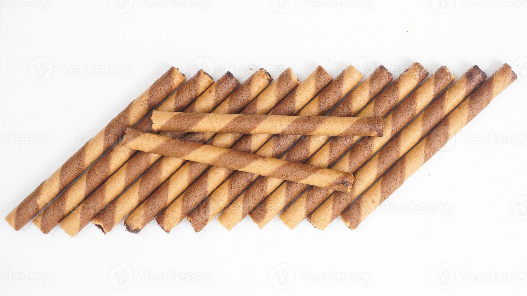 Gourmet chocolate wafer rolls with swirled layers isolated on white background photo