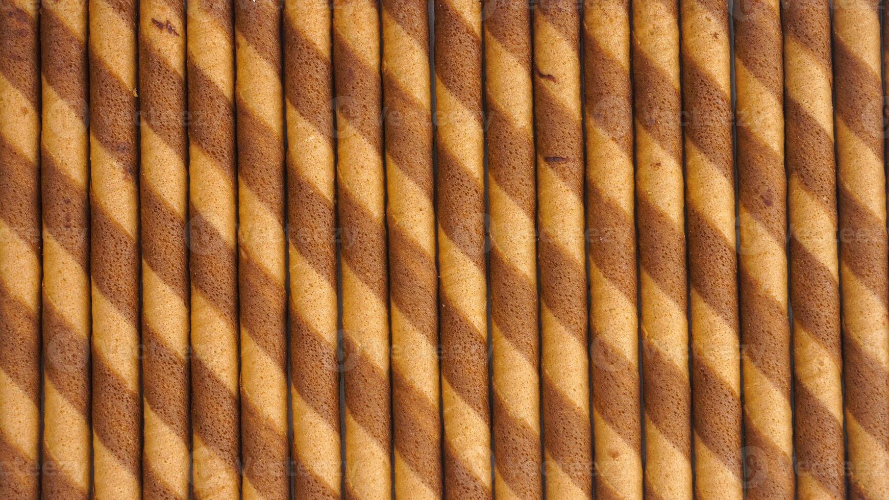Freshly baked chocolate wafer rolls isolated on white background photo