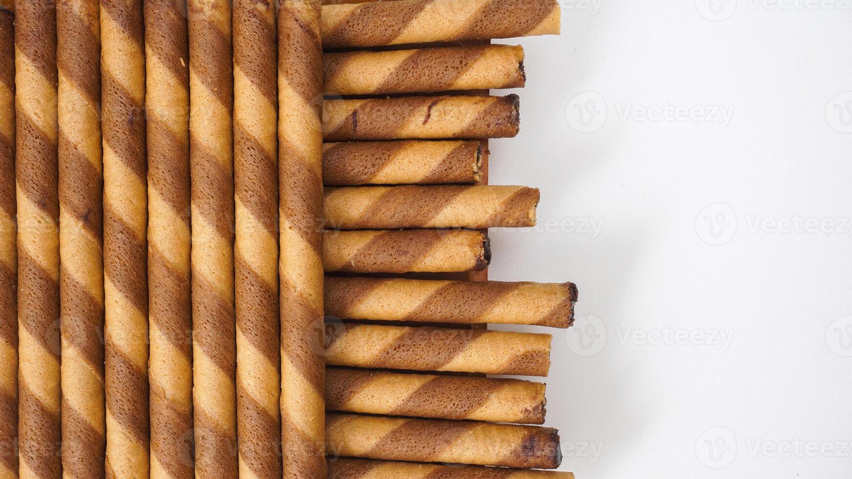 Sweet and crunchy chocolate wafer rolls in a neat arrangement isolated on white background photo