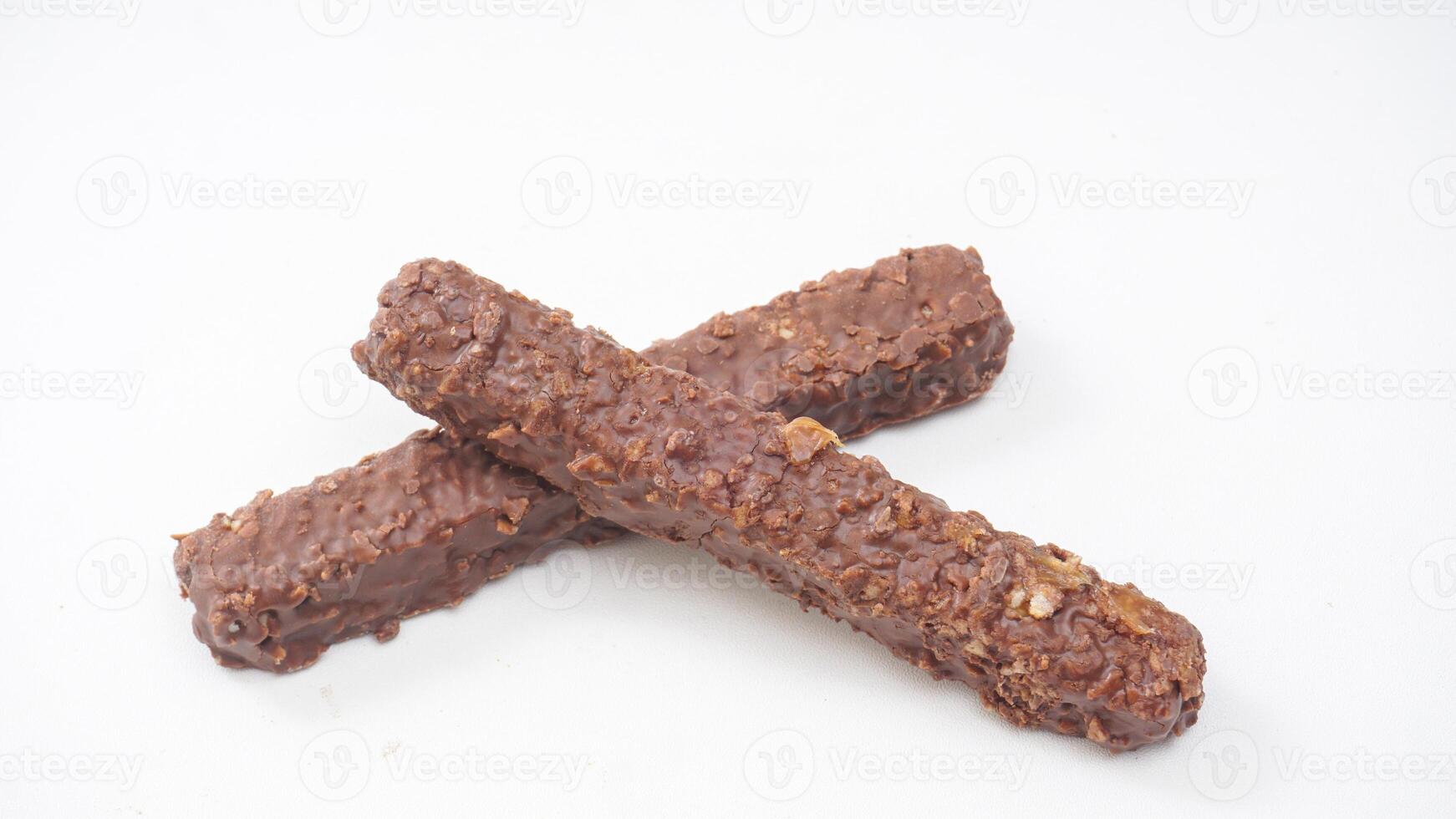 Delicious chocolate coated wafer bars with crunchy layers and caramel filling isolated on white background photo