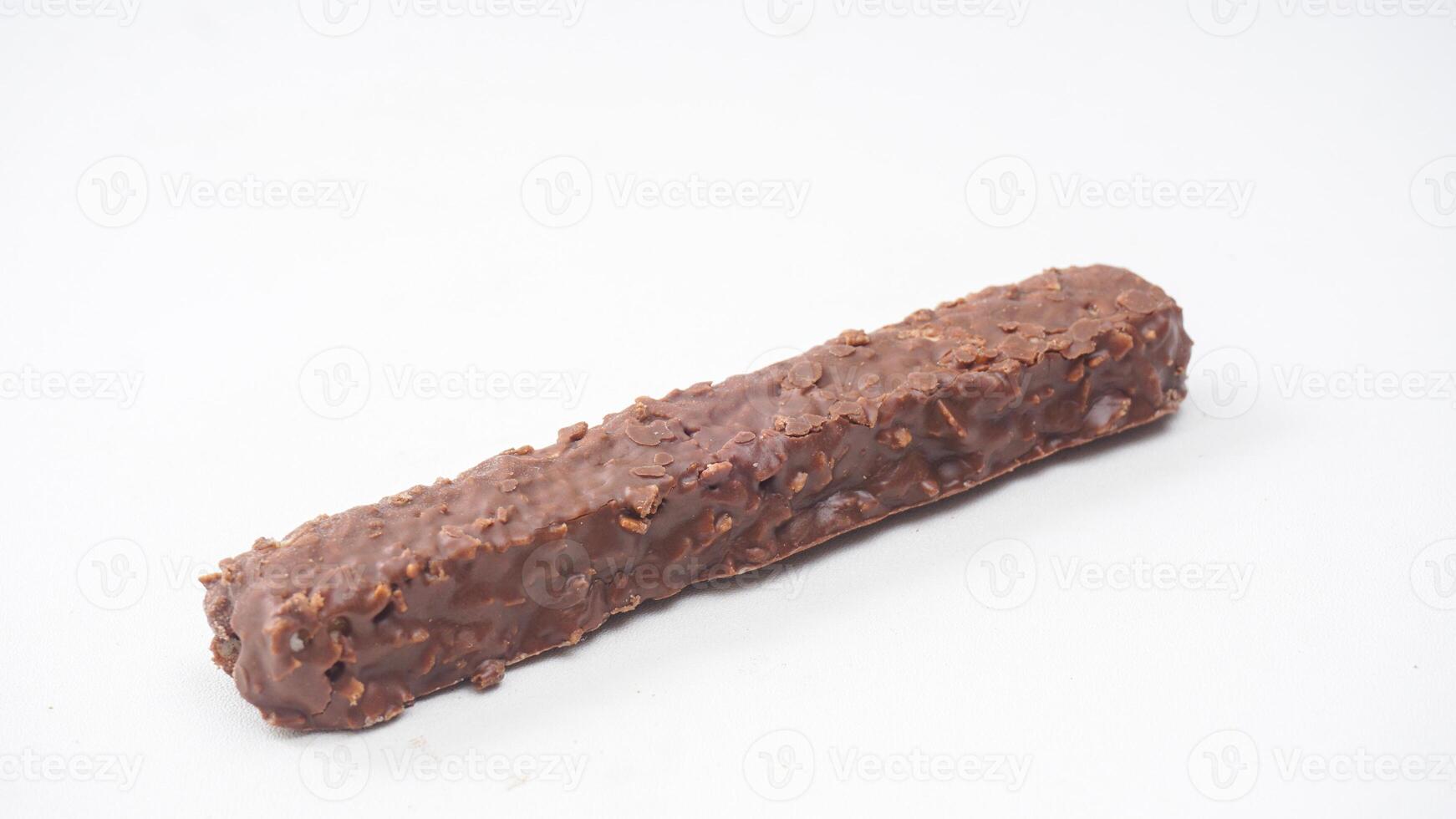 Crispy wafer bars covered in chocolate with caramel and rice crisps isolated on white background photo