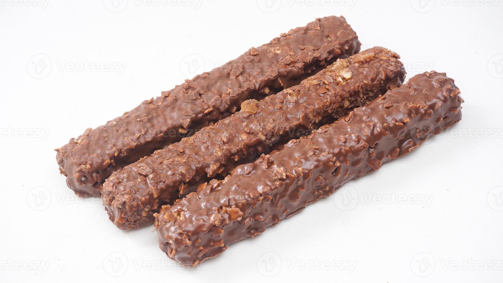 Crispy caramel wafer bars covered in milk chocolate and rice crisps isolated on white background photo