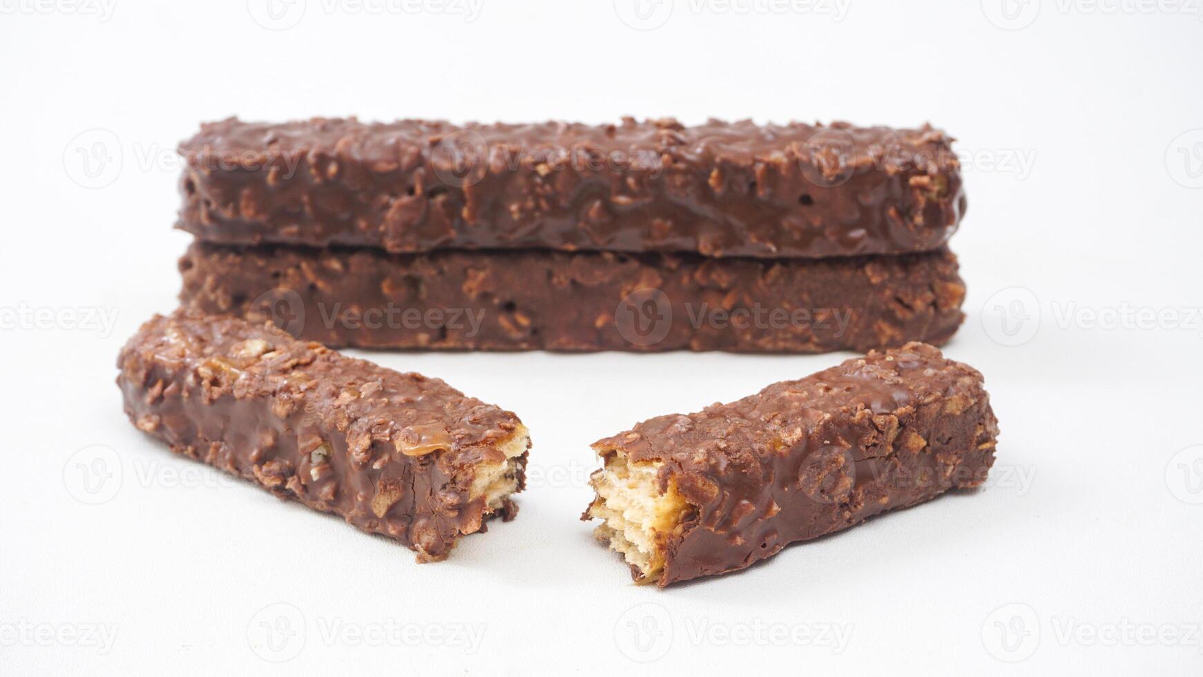 Crispy wafer bars with gooey caramel and chocolate coating isolated on white background photo