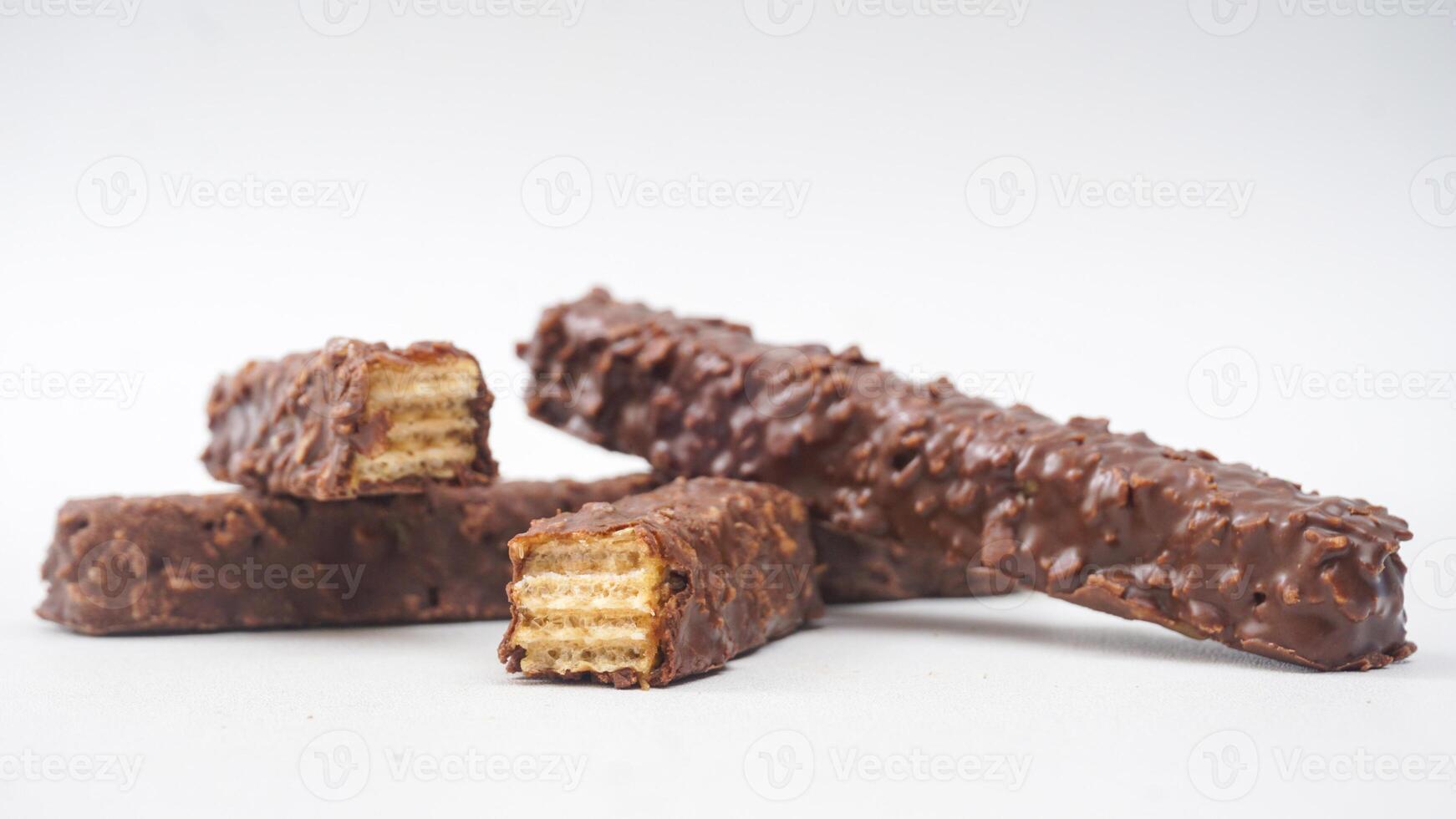 Chocolate caramel wafer bars with crunchy layers and rich coating isolated on white background photo