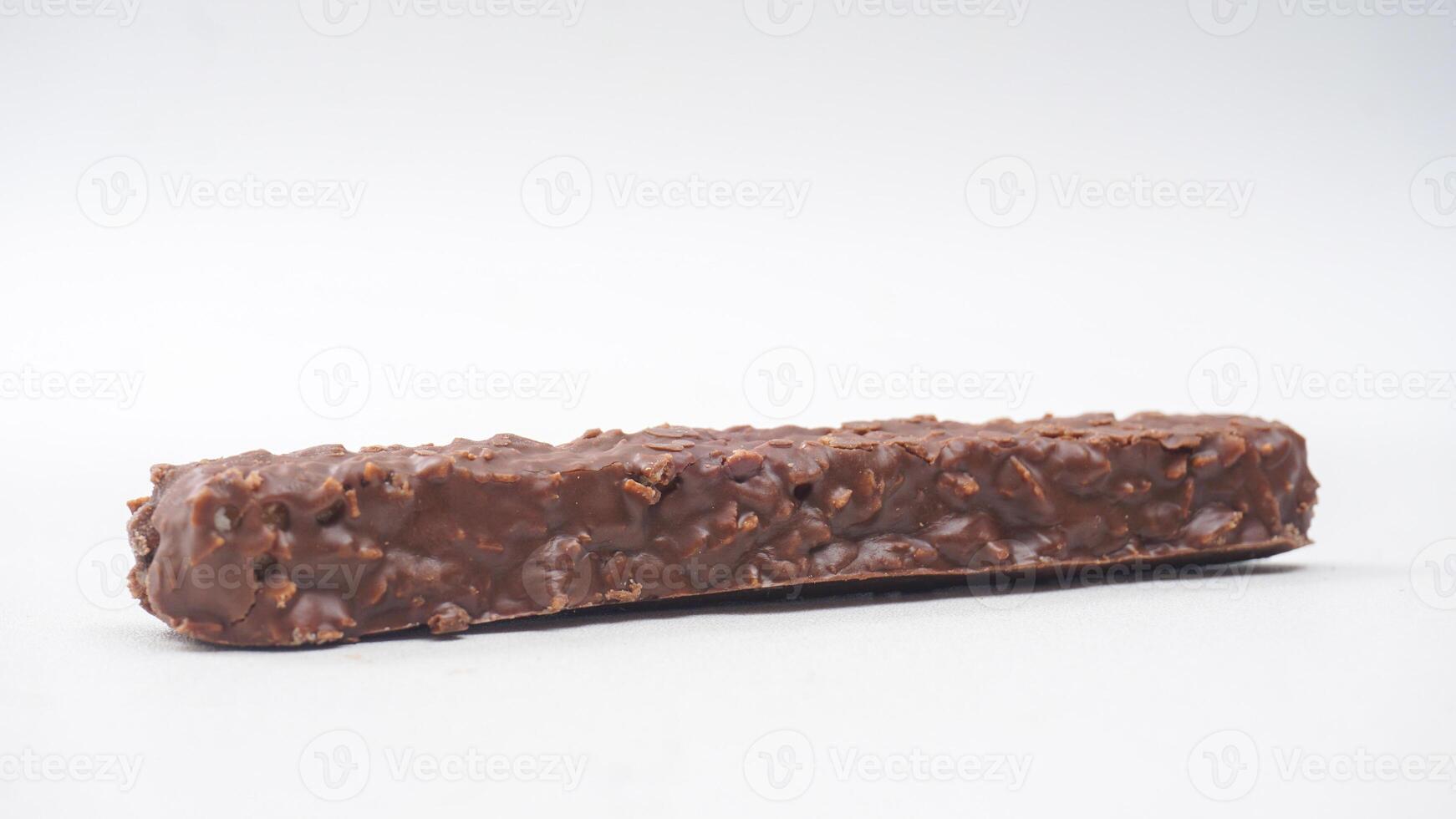 Chocolate coated wafer bars with crispy layers caramel and rice crisps isolated on white background photo