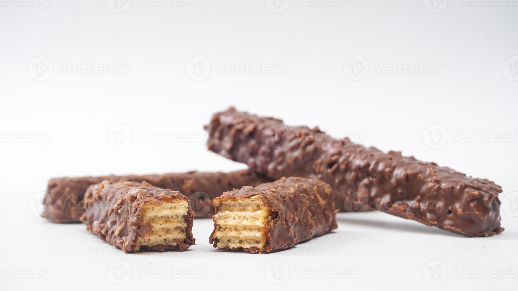 Crispy chocolate caramel wafer bars with smooth coating and rice crisps isolated on white background photo