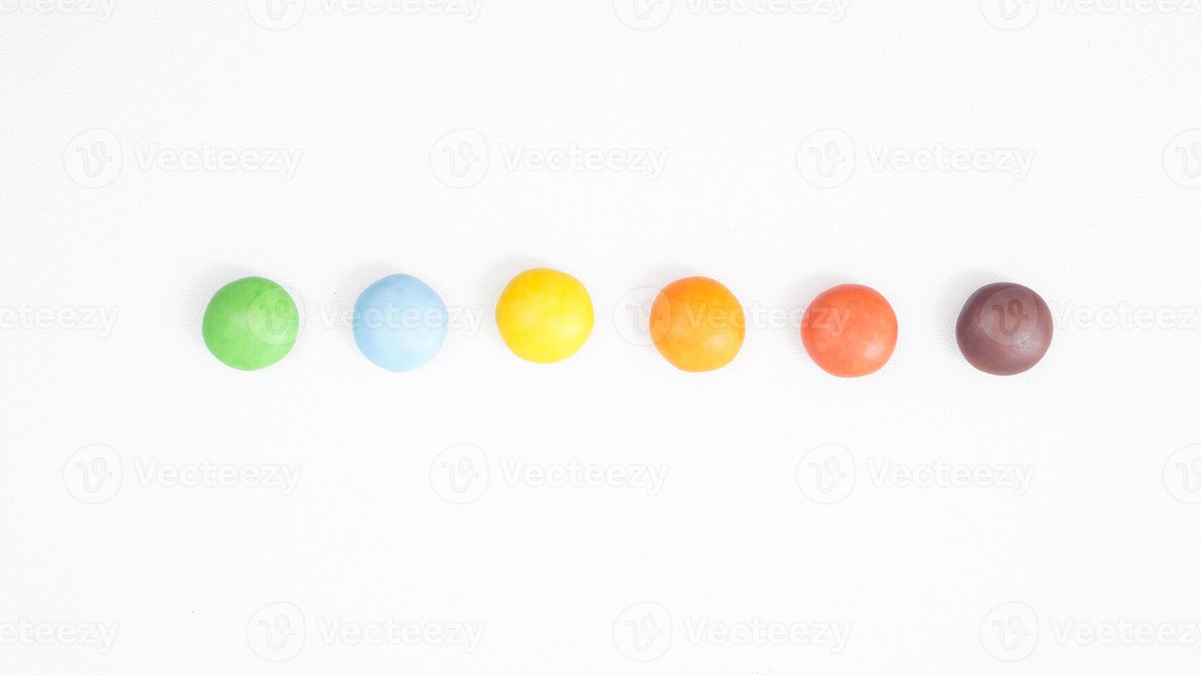 Sweet and colorful chocolate candies with a crunchy and thin sugar layer isolated on white background photo