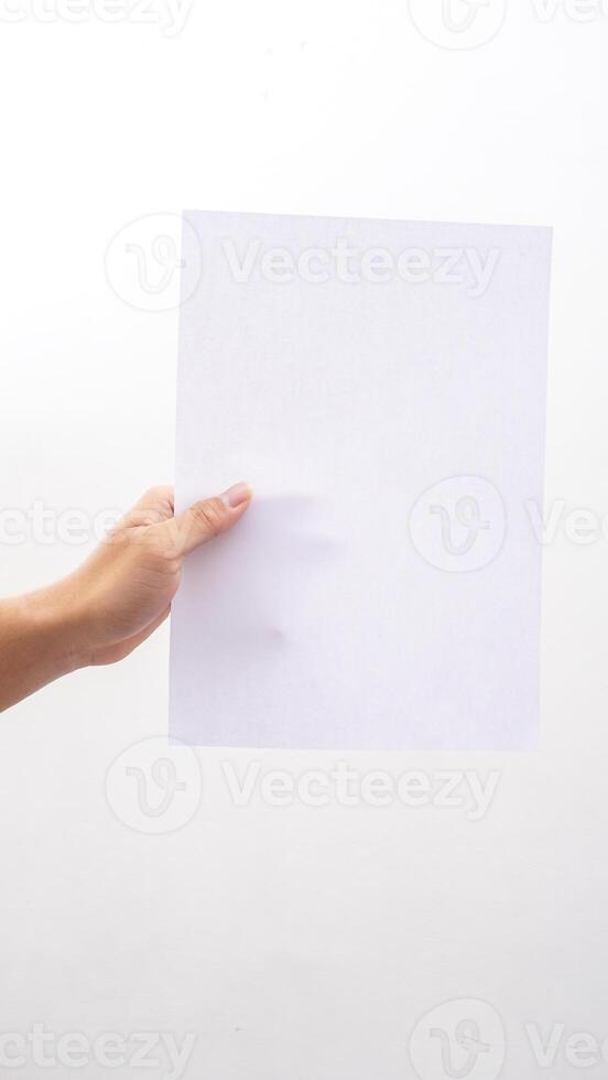 Hand holding blank white paper isolated on white background photo
