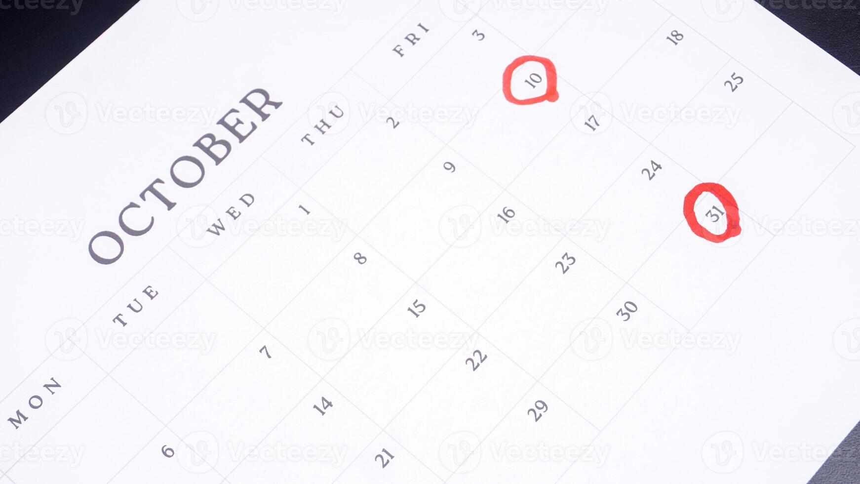 Red circle marked on a calendar at 10 and 31 of October photo