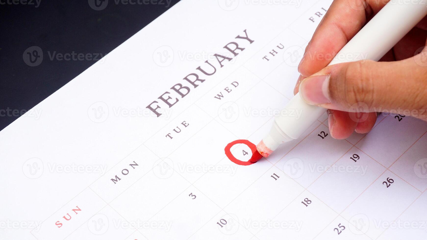 Red circle marked on a calendar at 4 of February as symbol of important day photo