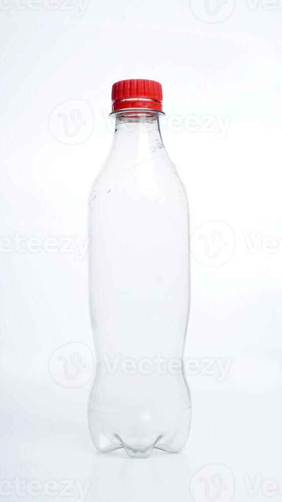 Empty plastic bottle with red bottle cap isolated on white background photo