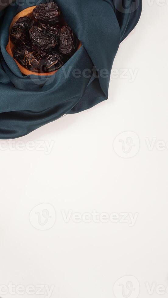 Muslim decoration for Ramadan and Eid al-Fitr with dark green fabric isolated on light background photo