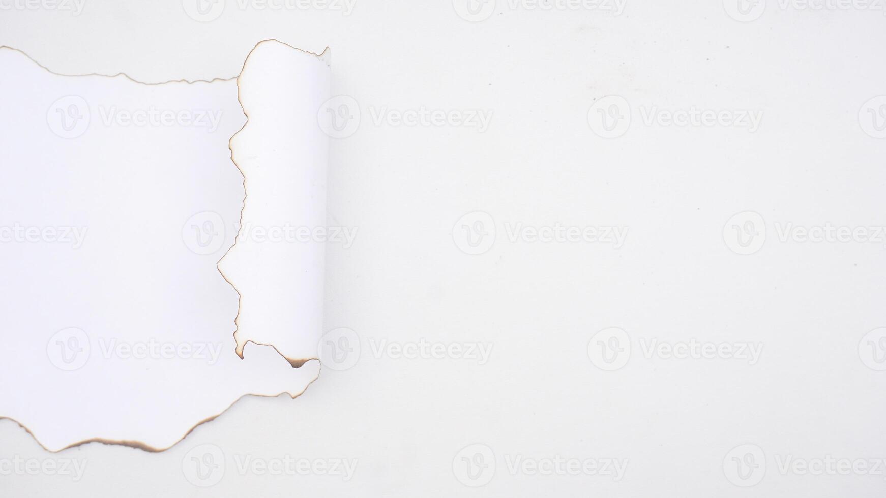 Burnt paper on the edges of white paper isolated on white background photo