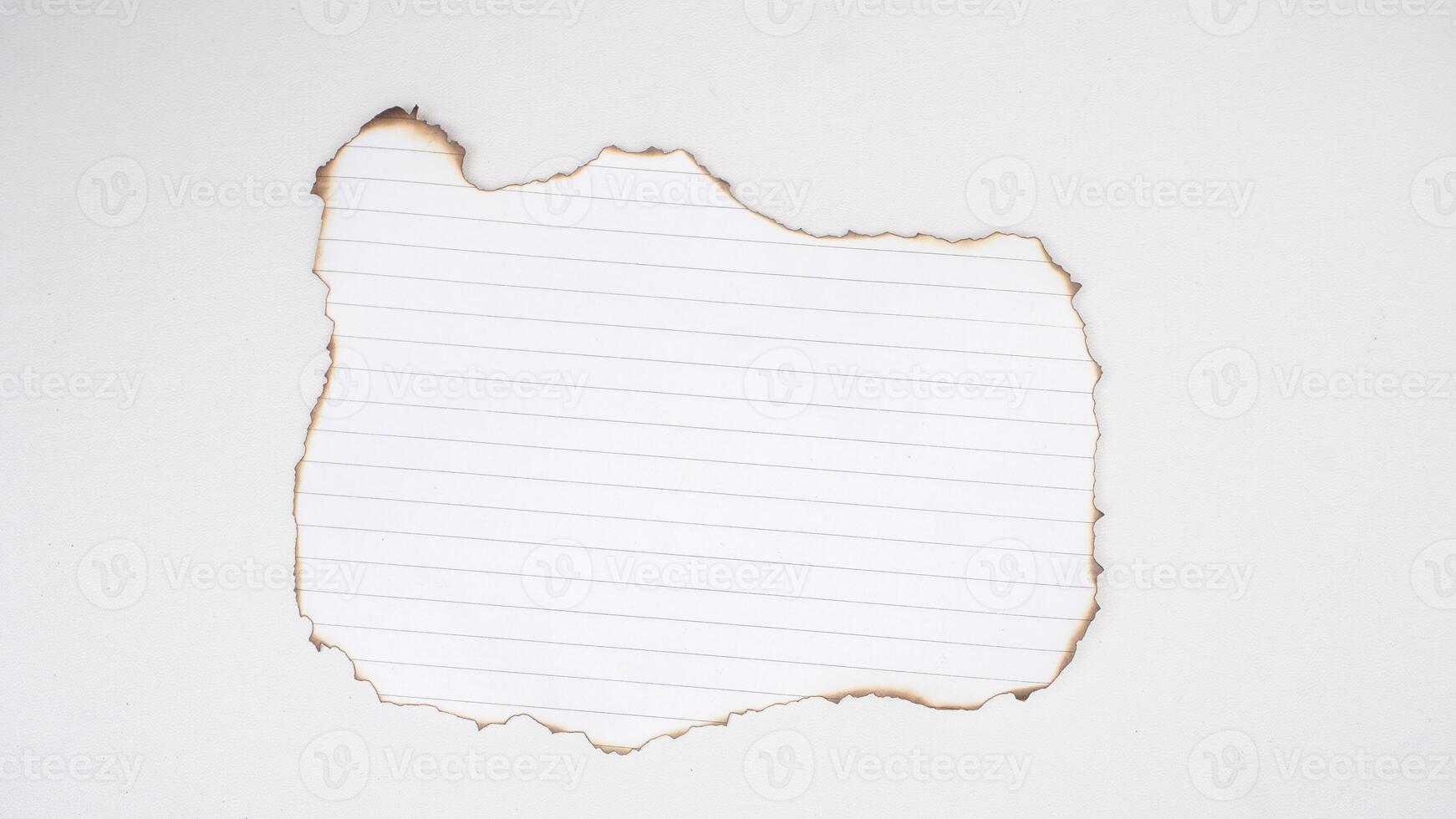 Burned edges white stripped paper isolated on white background photo