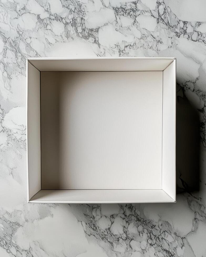 Empty white box on a marble surface, top view photo