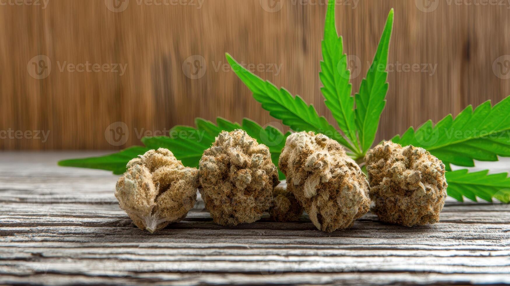 Close up of cannabis buds and leaf on a wooden surface photo