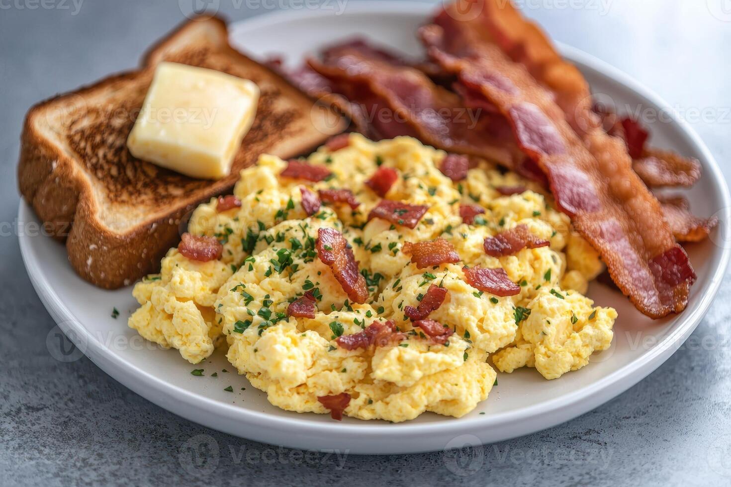Delicious breakfast plate with scrambled eggs, bacon, and toast photo