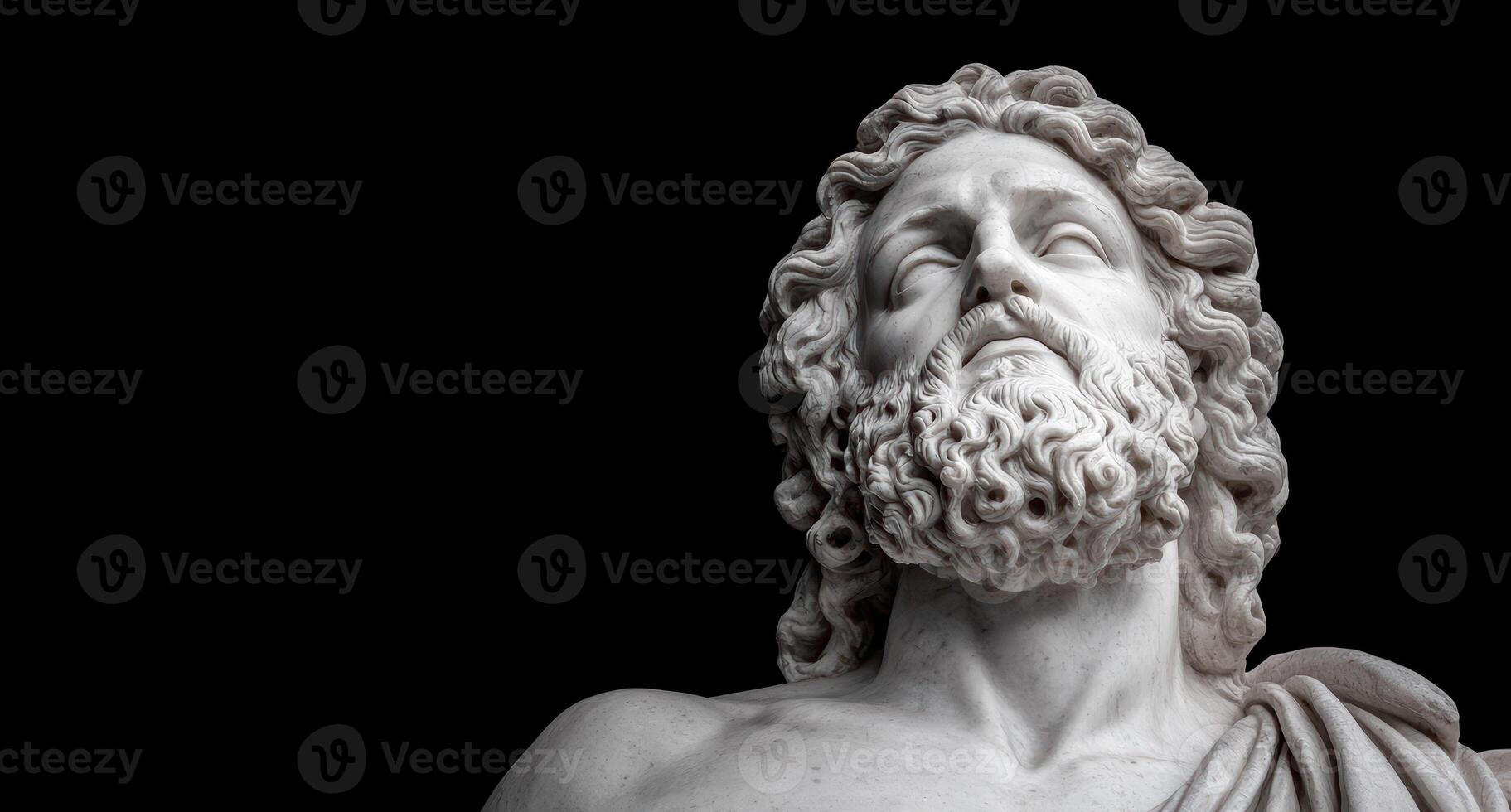 Marble statue of a bearded man with curly hair looking up photo