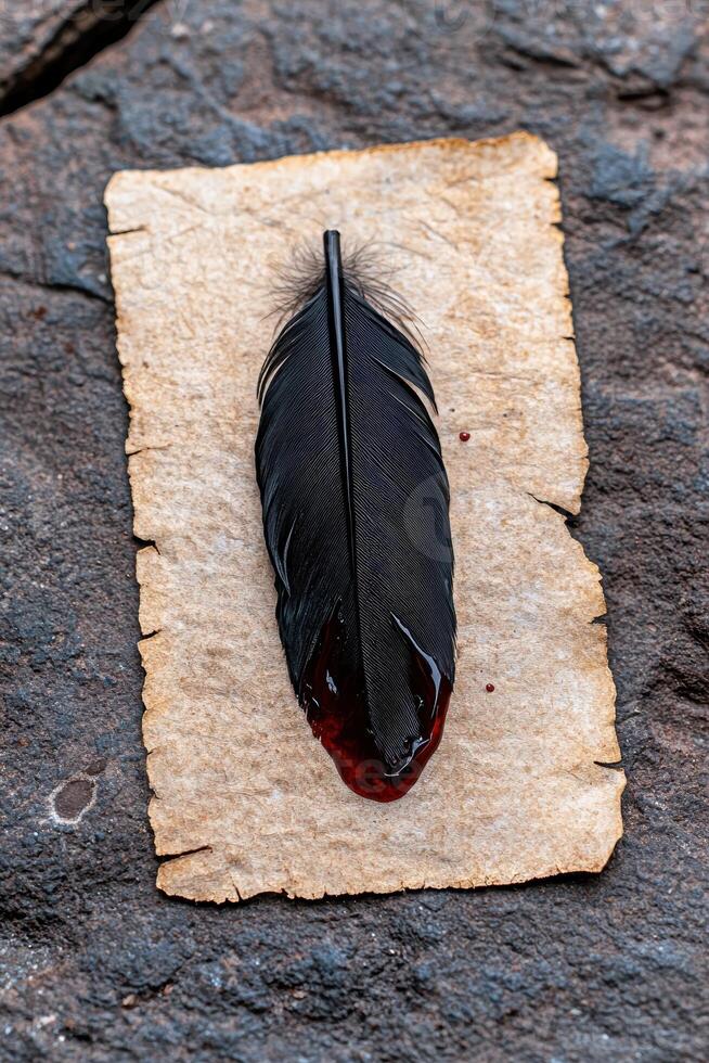 A black feather with red liquid on parchment paper photo