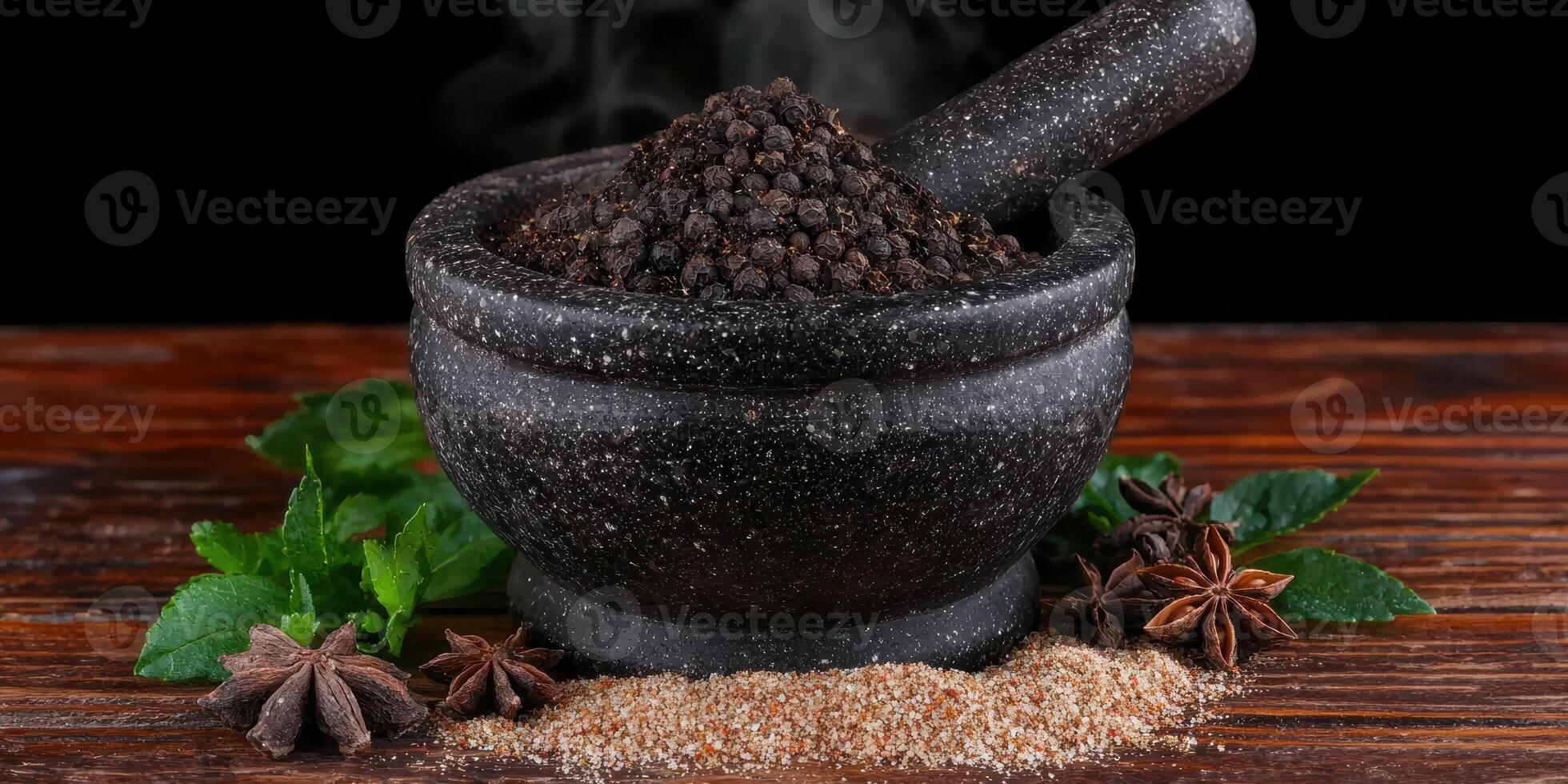 Black peppercorns in a mortar with pestle, star anise, and mint leaves photo