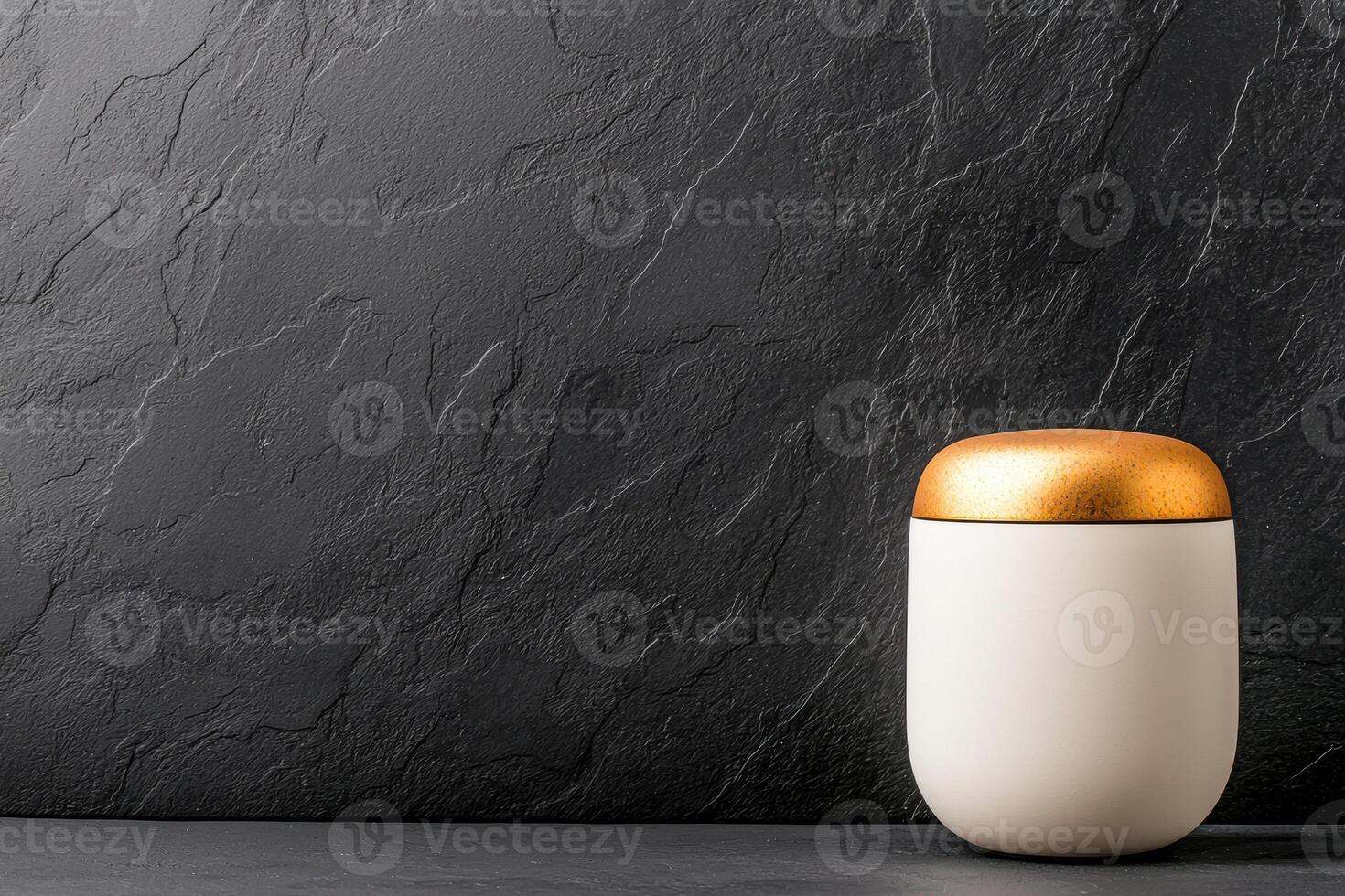 sleek electronic container with golden lid sits elegantly against textured black background, showcasing modern design and style photo