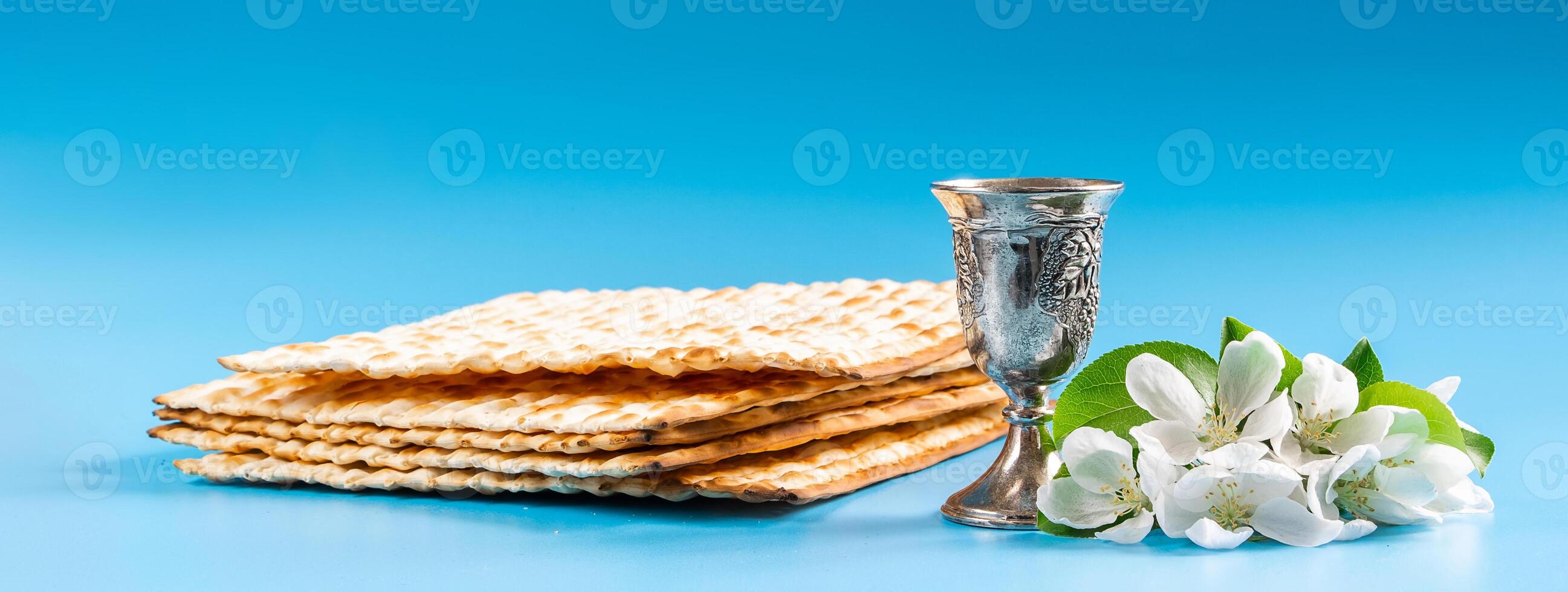 Happy passover. Metal goblet and traditional matzah on blue background photo