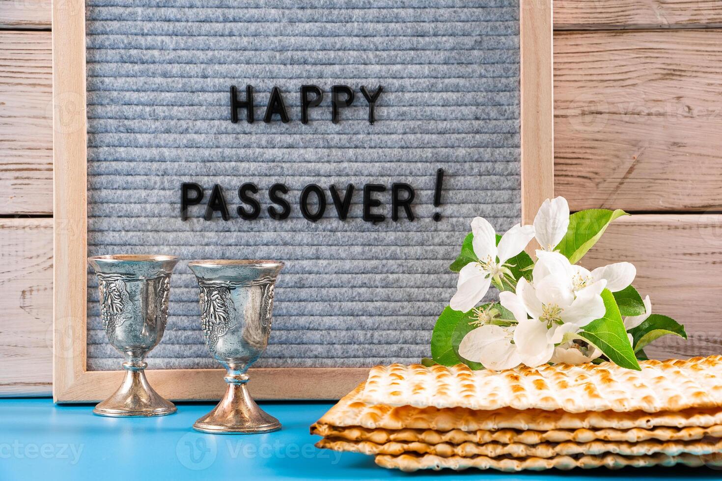 Happy Passover. Metal wine glasses and traditional Jewish matzo bread photo