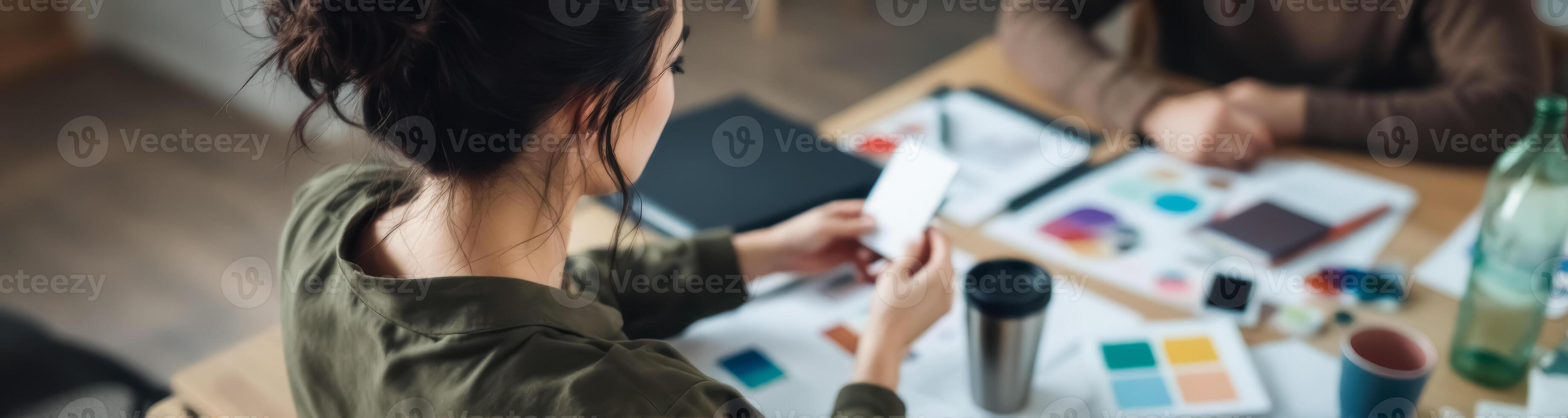young woman reviewing samples at a work table photo