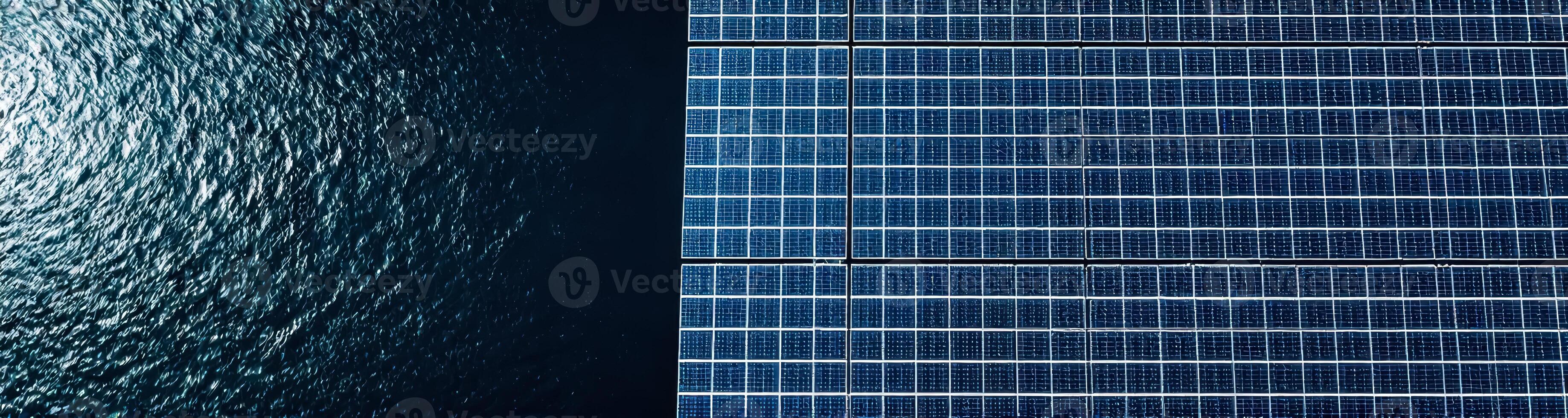 high-angle view of a solar panel system beside dark blue water photo