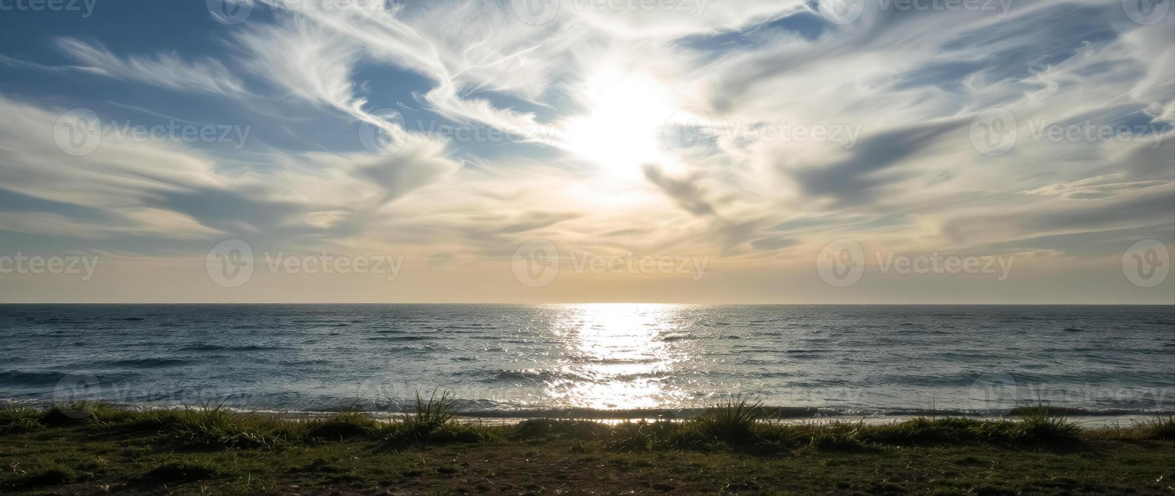 tranquil ocean sunset with golden sky and calm waves photo