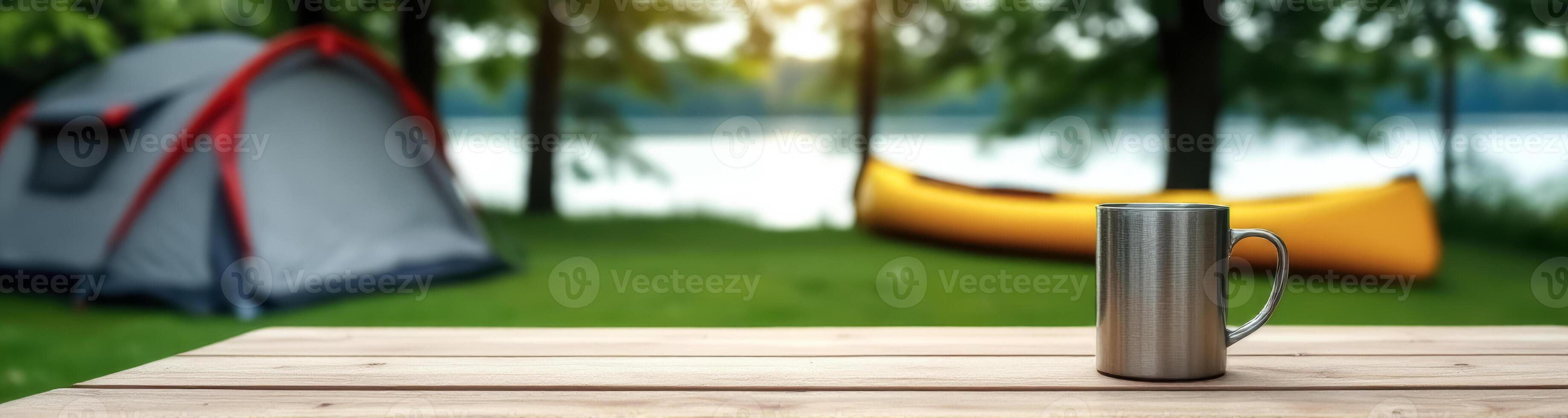 brushed metallic mug on wooden table with blurred camping and background photo
