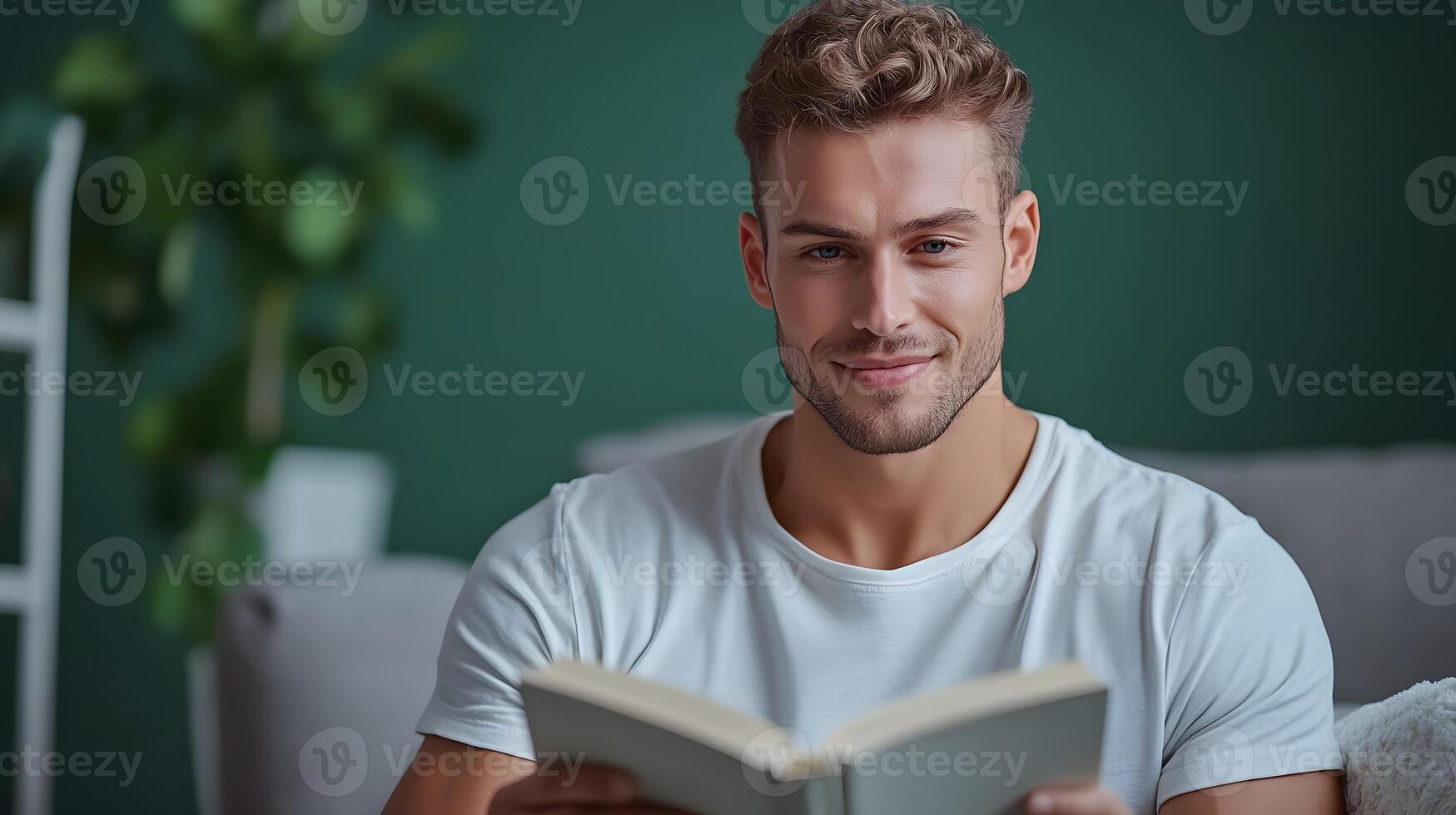 A man sits comfortably on a couch deeply engrossed in reading a book in a peaceful and inviting living room setting photo