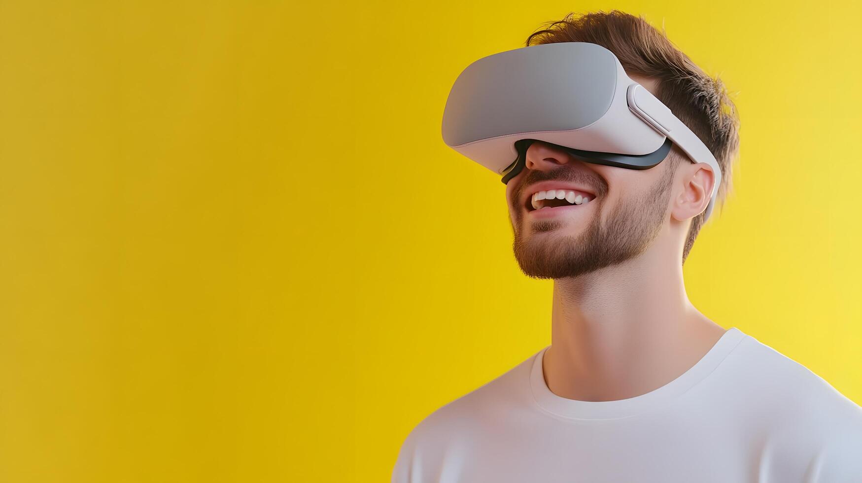 A young man with a virtual reality headset on smiling and excited as he experiences an immersive digital world through the latest VR technology photo