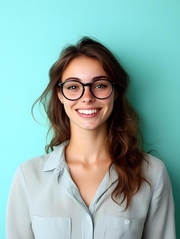 Portrait of a cheerful confident young woman with glasses and an engaging friendly expression photo