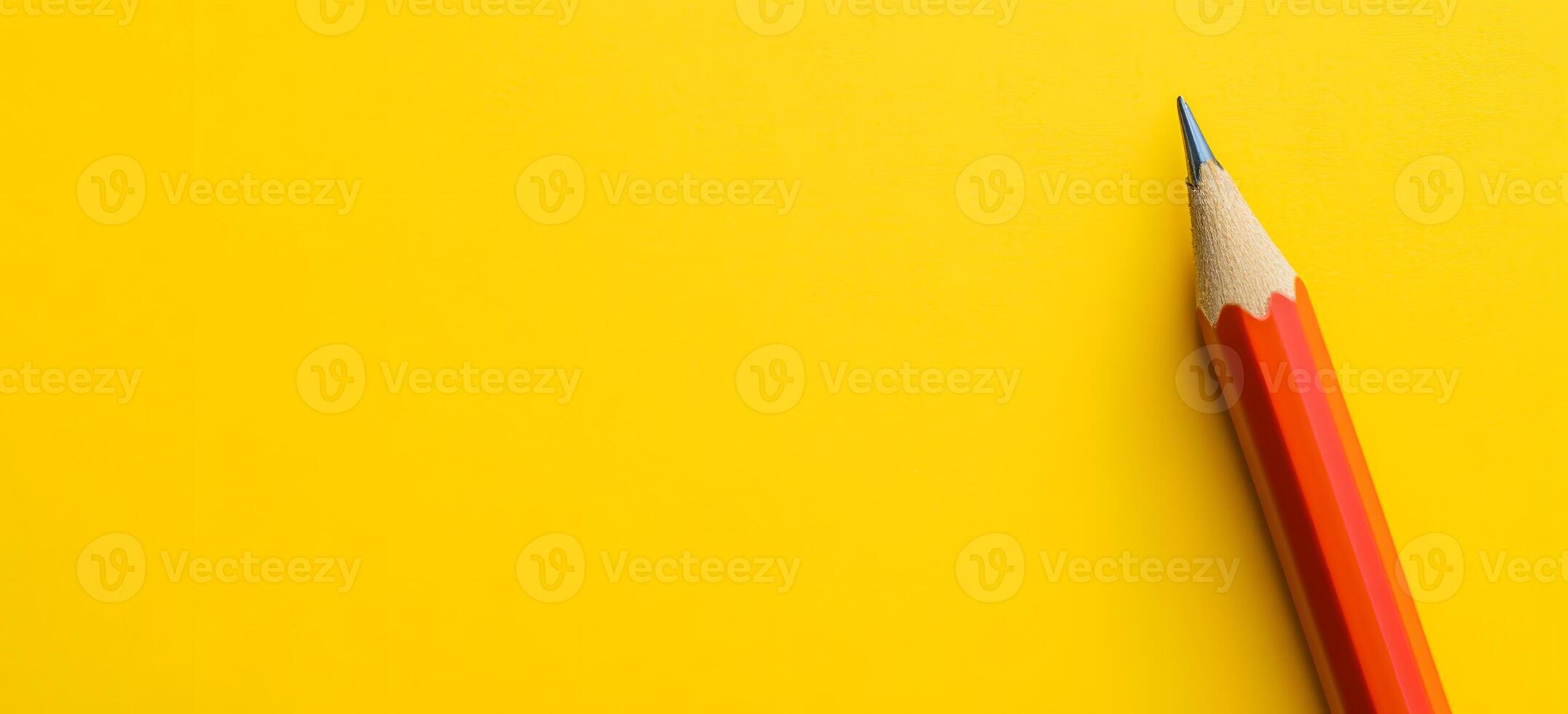Sharp Yellow Pencil on Vibrant Yellow Background for Creative and Educational Concepts photo