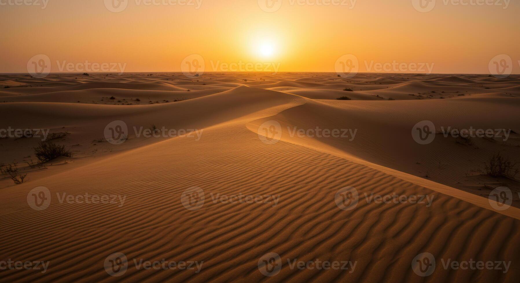 Golden sunset bathes the serene desert dunes in warm, inviting light creating a tranquil scene. photo