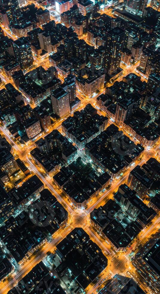 A captivating nighttime aerial view showcases a brilliantly lit city's structured grid. photo