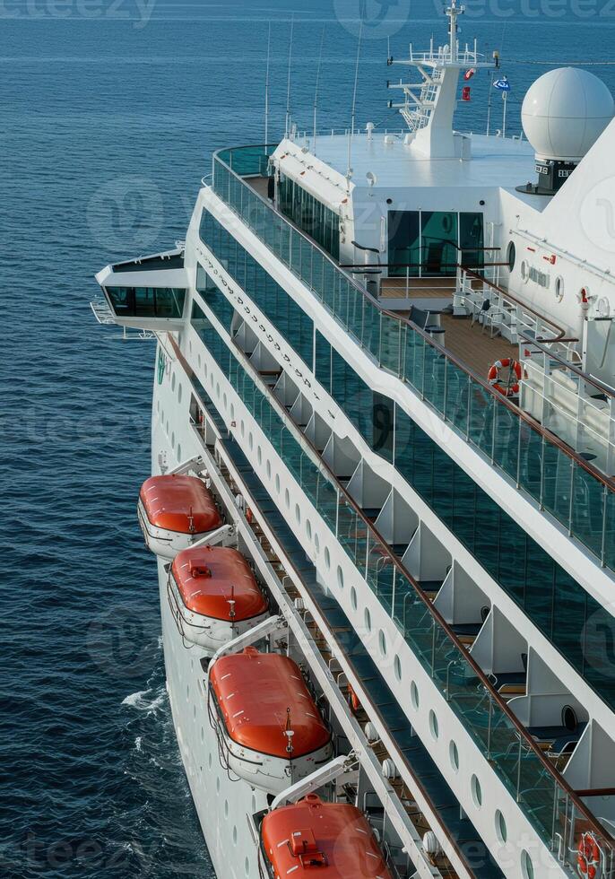 An ocean cruise ship sailing on a blue sea showcasing its cabins and lifeboats. photo