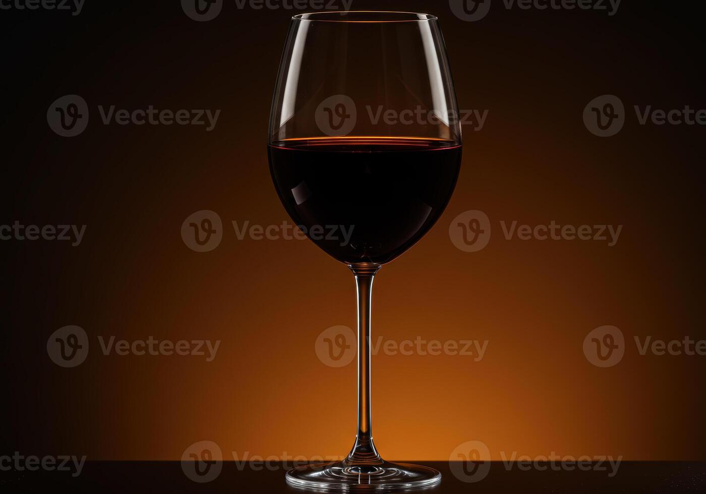 A perfectly poured glass of red wine stands ready for a toast, bathed in soft light. photo