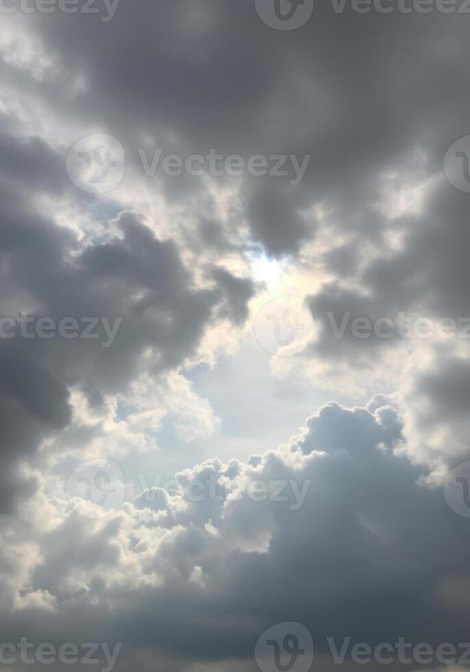 A break in the clouds reveals a bright, sunny sky, illuminating the day ahead. photo