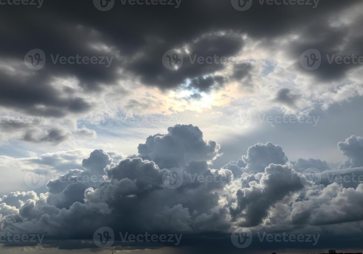 A dramatic sky filled with dark rain clouds gathering and obscuring the horizon. photo