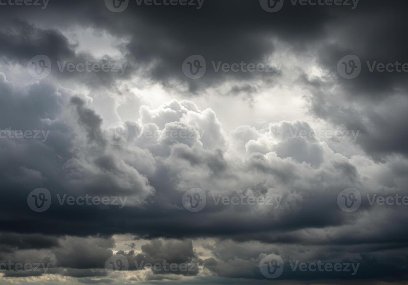A dramatic sky filled with fluffy grey clouds creates a powerful atmosphere. photo