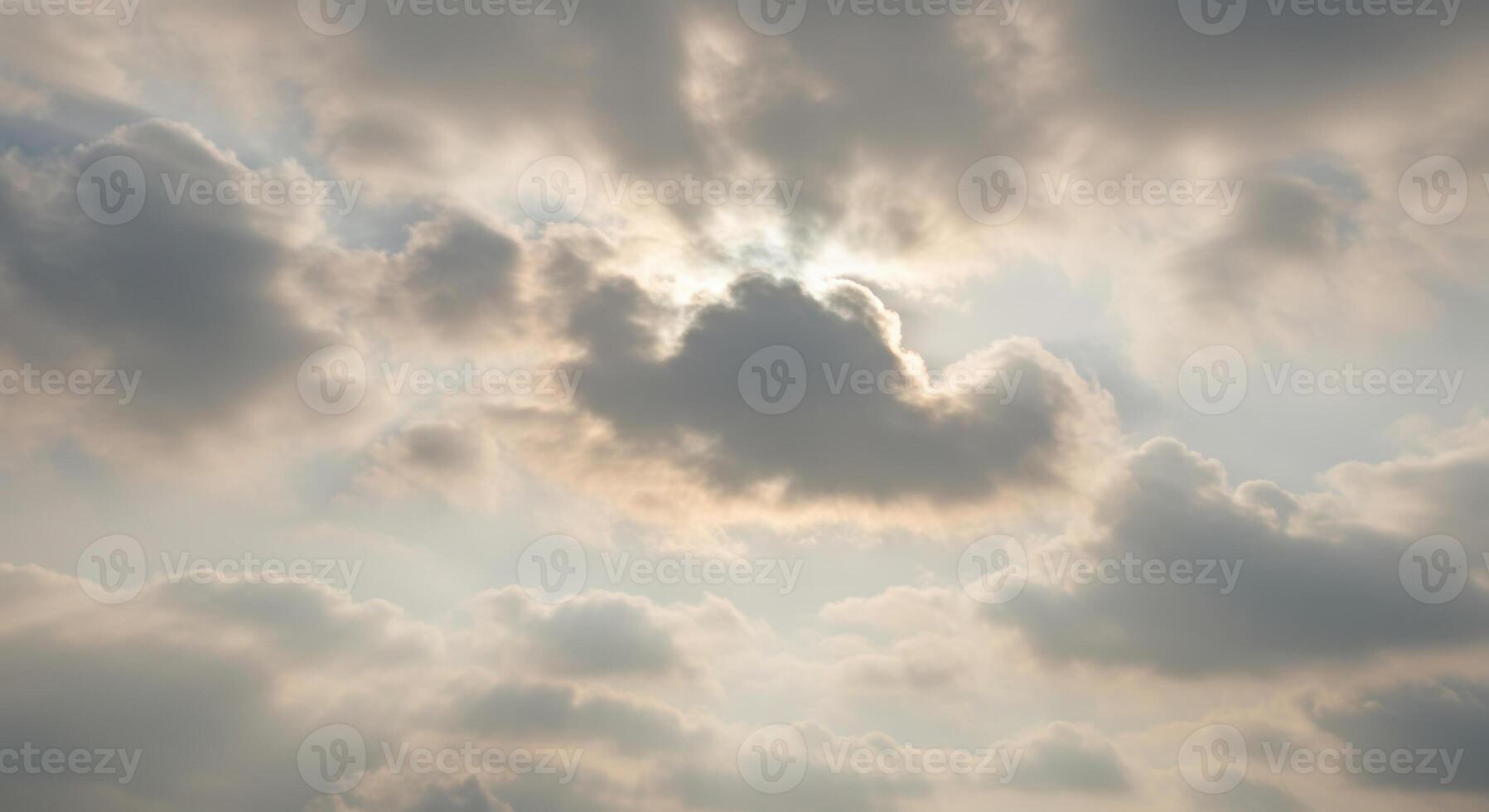 Sun rays filtering through the clouds create a serene and luminous skyscape. photo
