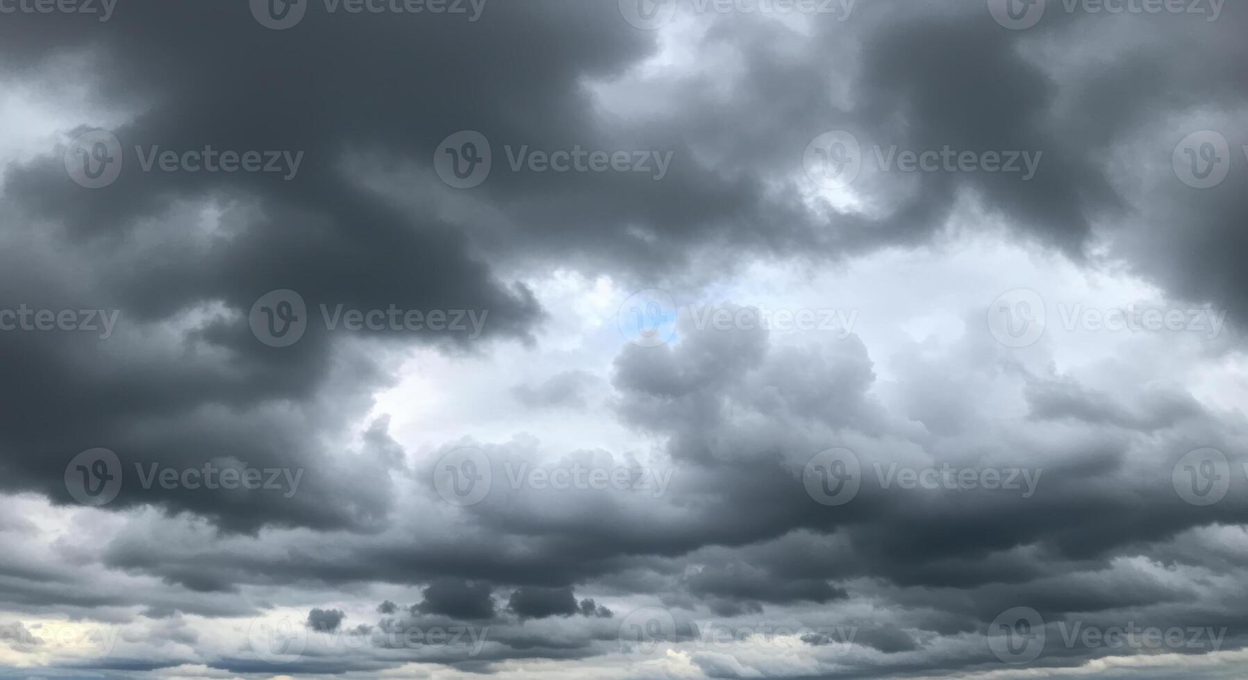Dark storm clouds filling the sky create a dramatic, ominous weather scene. photo