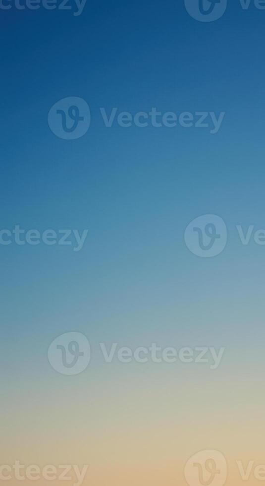 Soft gradient of orange to blue evokes feelings of peace, sunset or sunrise. photo