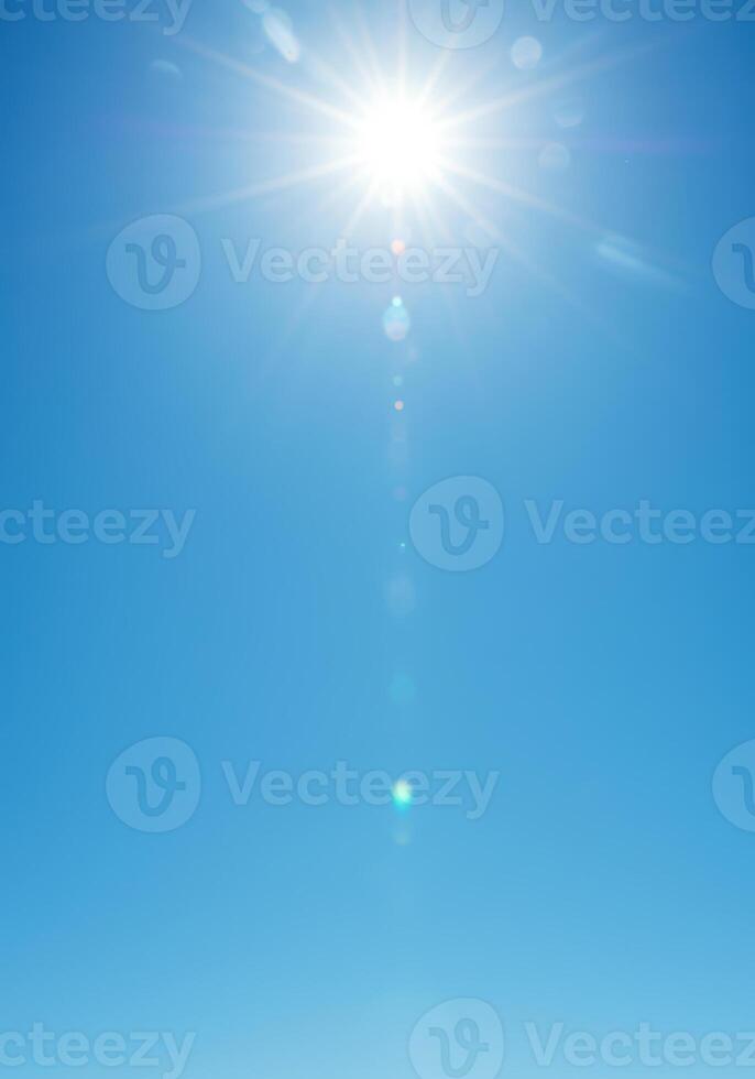 The sun shines brightly in a blue sky creating a fresh, sunny skyscape. photo