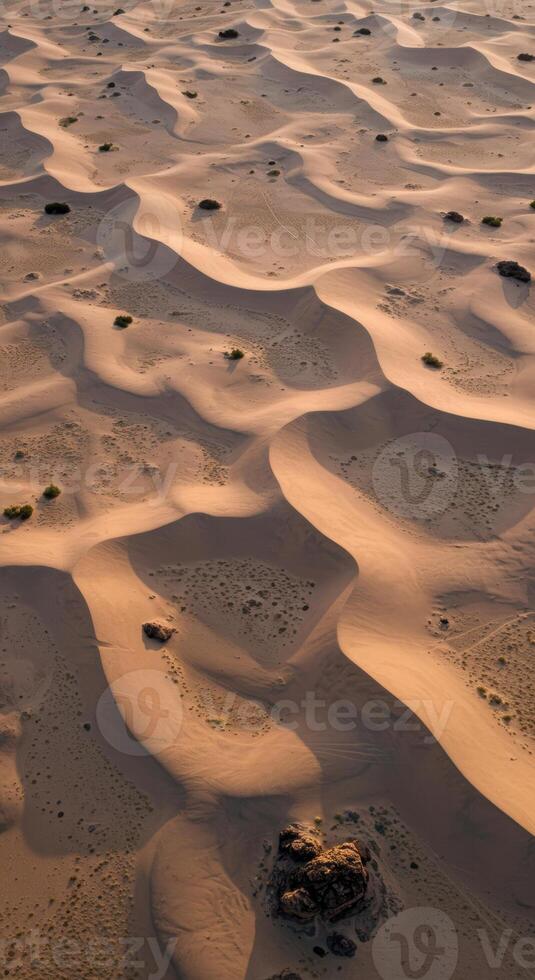 Stunning aerial perspective showcasing intricate patterns of desert sand dunes and subtle vegetation. photo