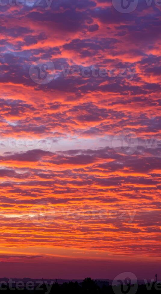 The setting sun illuminates the sky with stunning colors, creating a beautiful and majestic scene. photo