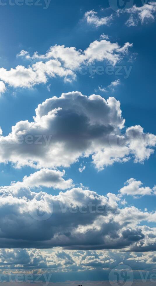 The stunning blue sky is adorned with fluffy, white and gray clouds. photo