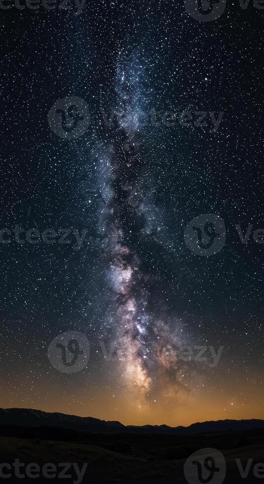 A breathtaking view of the Milky Way galaxy illuminates the night sky above a mountain range. photo